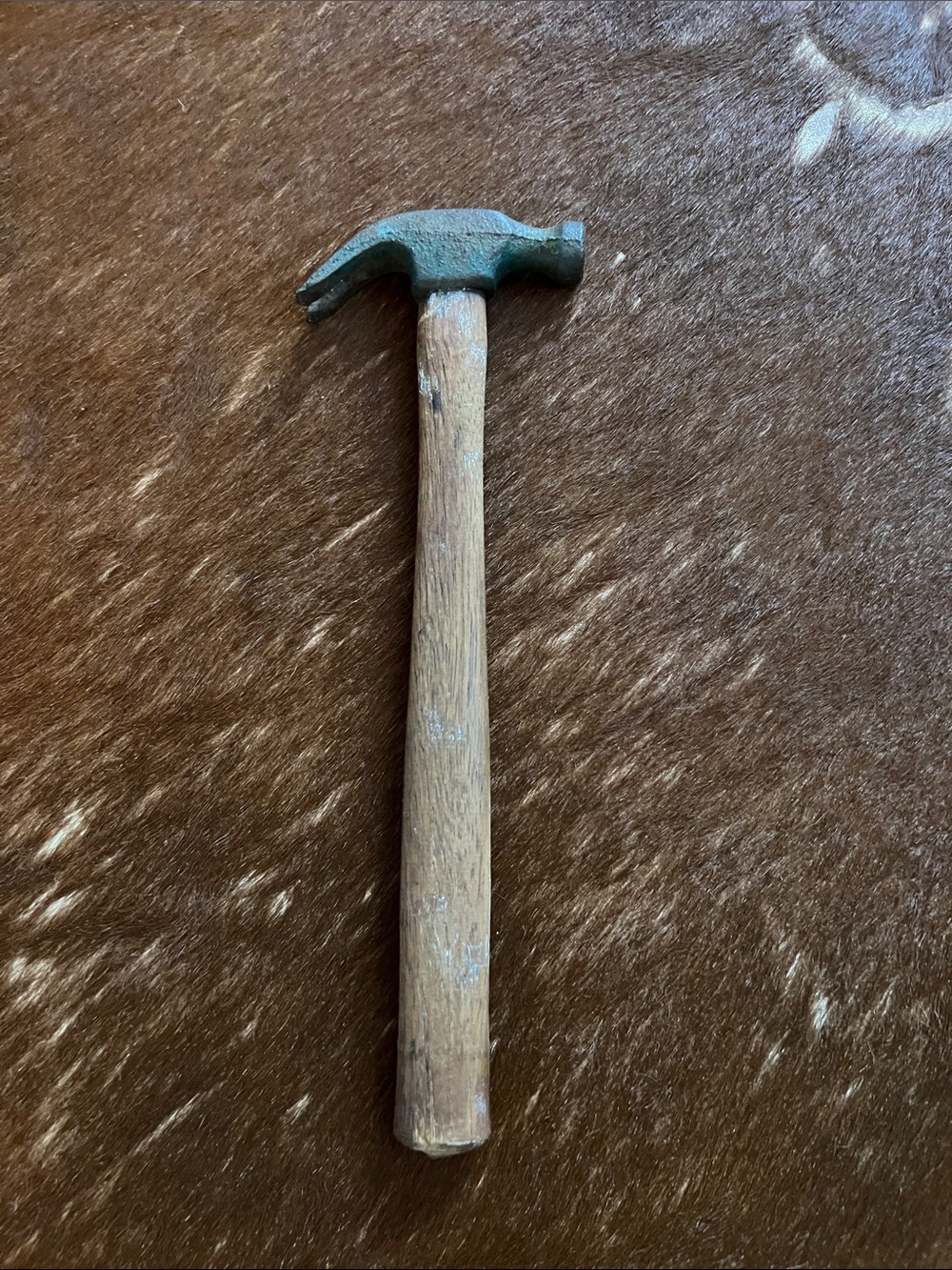 vintage claw hammer with a steel head and a wooden handle